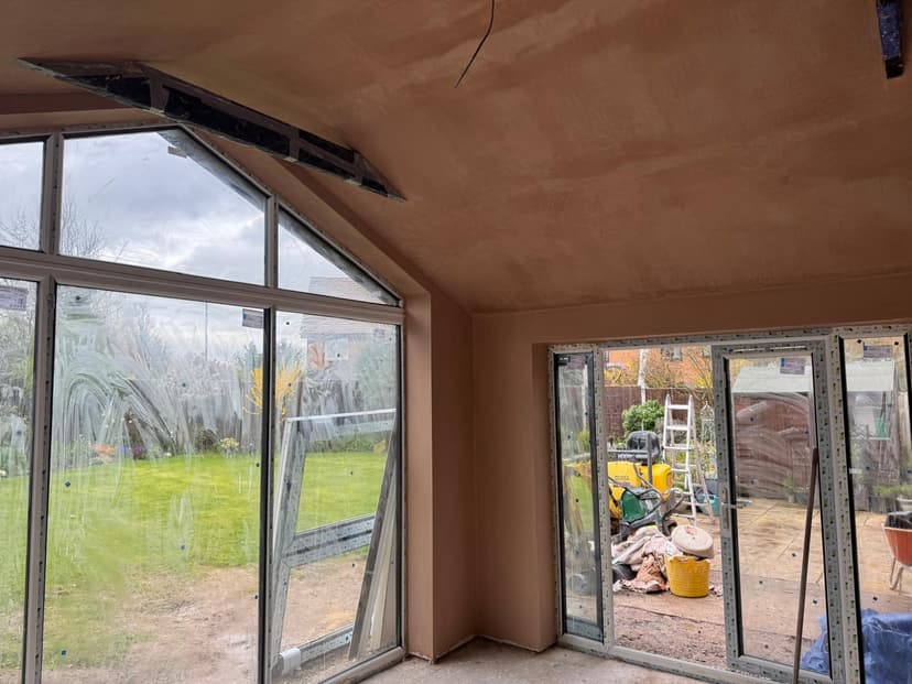 Kitchen extension with smooth plastered walls and tiled floor