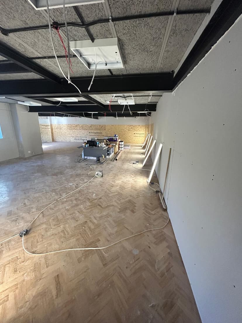 Built-in media wall with shelving and plaster finish