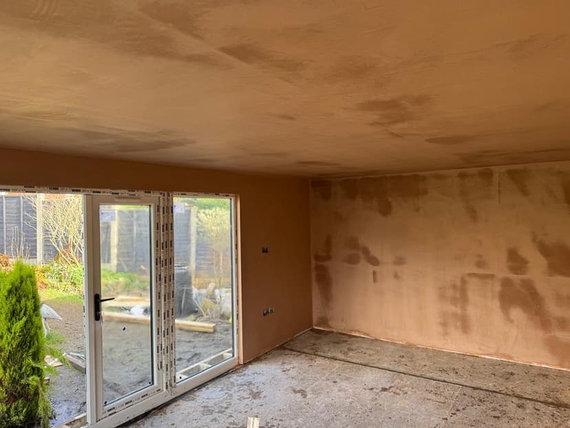 Plaster patching around a window opening in an office
